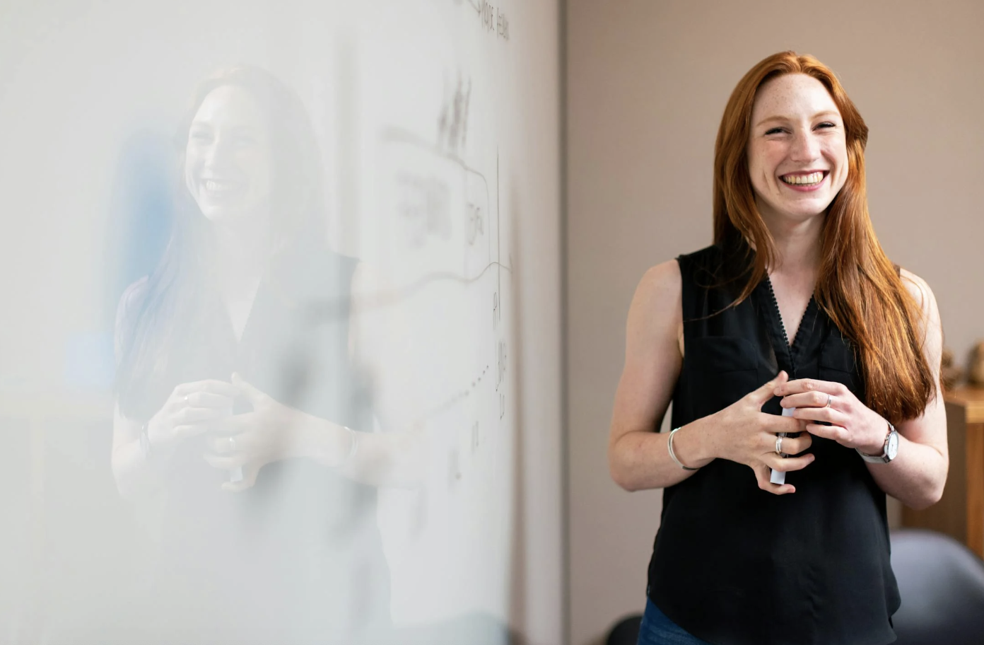 A woman giving a presentation at an office. 