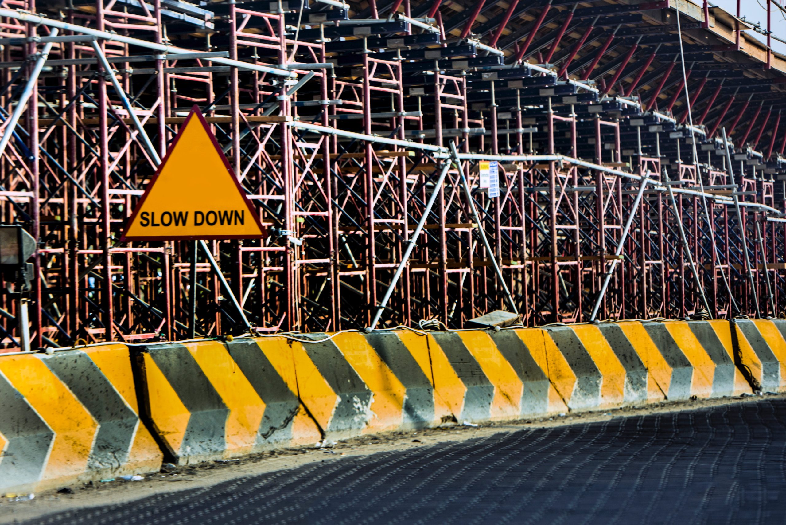 A sign that says slow down and behind it is a construction zone.