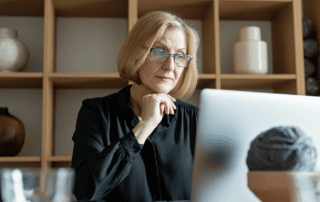 A woman working in front of a laptop.