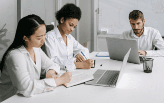 Employees Busy Working Using Laptop