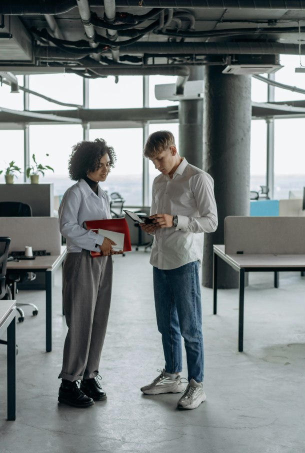 Photo of two co-workers checking each others work.