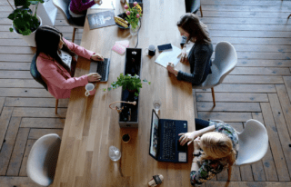 Workplace with three people working.