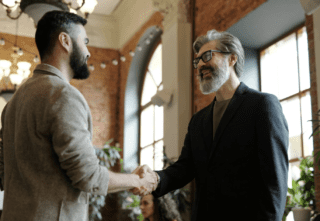 Two men shaking hands making a deal.