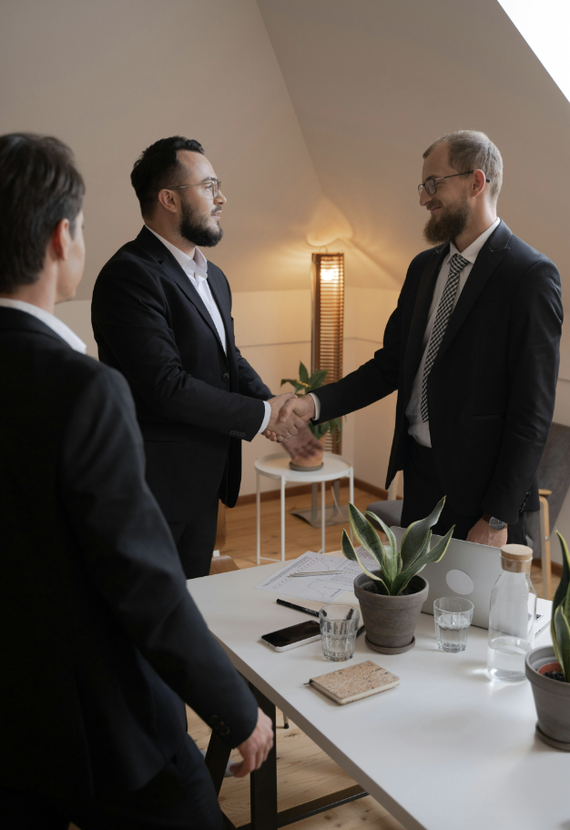 Two executives shaking hands in agreement. 