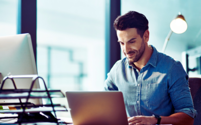 A man working intently on a laptop.