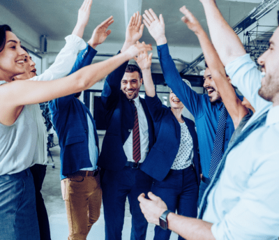 A group of office workers high-fiving.